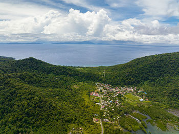 High angle view of townscape by sea against sky