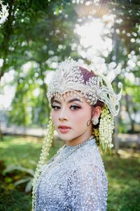 Portrait of young woman standing outdoors