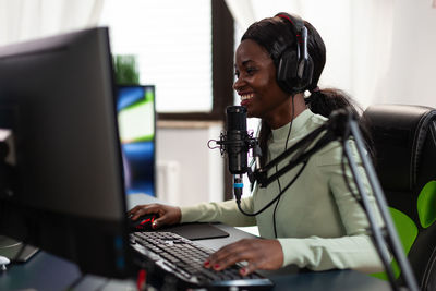 Female gamer playing game on computer