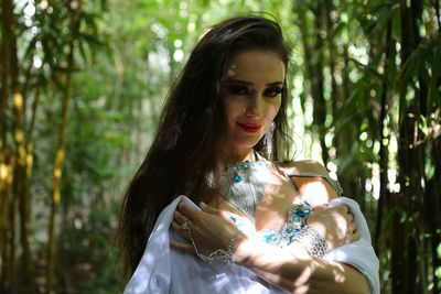 Portrait of beautiful young bellydancer wearing her belly dancing outfit and standing outdoors