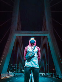 Full length of man standing on illuminated stage