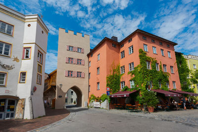 Street amidst buildings in town against sky