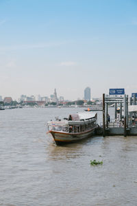 Boat on sea against sky in city