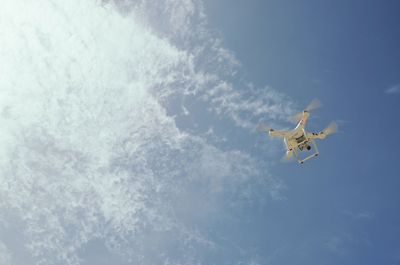 Low angle view of airplane flying in sky