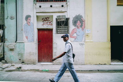 Full length of man standing against wall