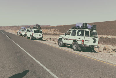 Cars on road against clear sky