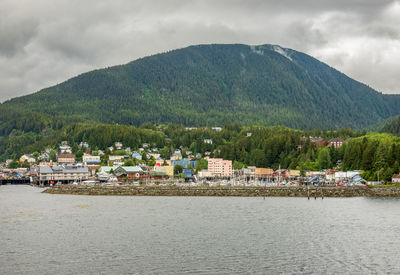 Scenic view of townscape and mountains against sky