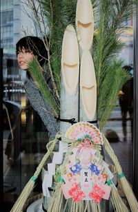 Boy standing behind religious decoration