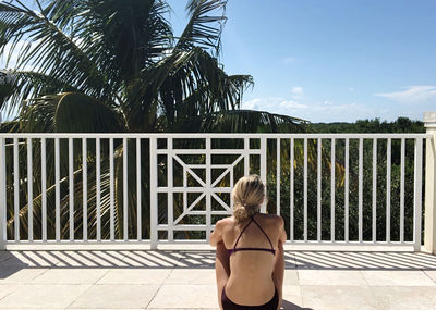 Rear view of woman looking at swimming pool