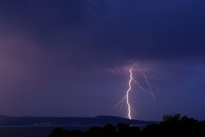 Low angle view of lightning against sky at night