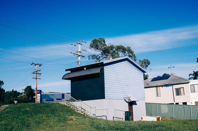 Houses on field against sky
