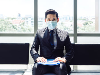 Man sitting in front of window