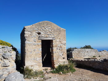 Old ruins against clear blue sky