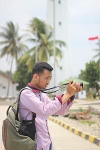 Side view of man photographing