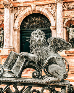 Low angle view of angel sculpture on old building