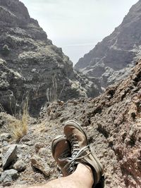 Low section of person on rock in mountains