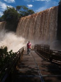 Woman looking at waterfall