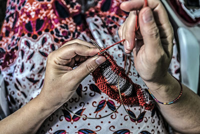 Midsection of woman knitting wool