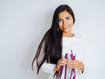 Young beautiful brunette woman with long hair taking tapes in her hands