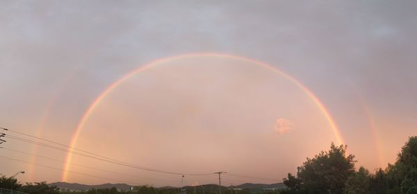 Low angle view of rainbow over city