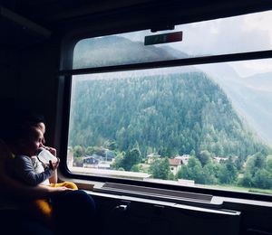 Man looking through train window
