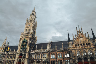 Low angle view of clock tower against sky in munich 