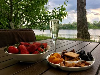 Life in nature, strawberries, prosecco, other snacks, river, picnic.