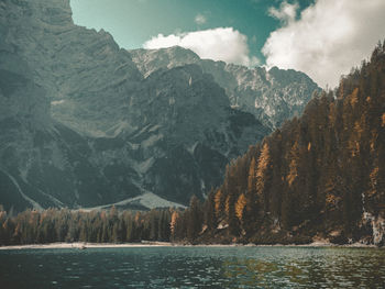 Scenic view of lake by mountains against sky