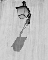 Low angle view of street light mounted on wall