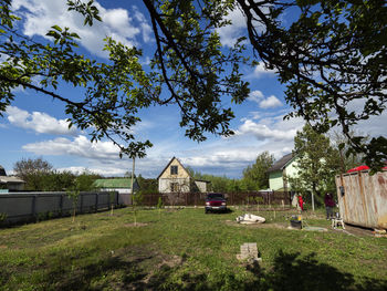 Built structure by trees against sky