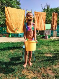 Portrait of girl standing in yard