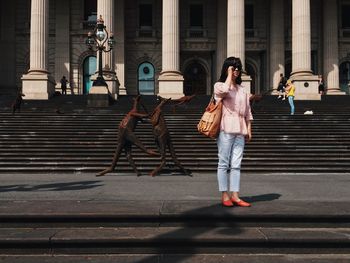 Woman standing in front of building