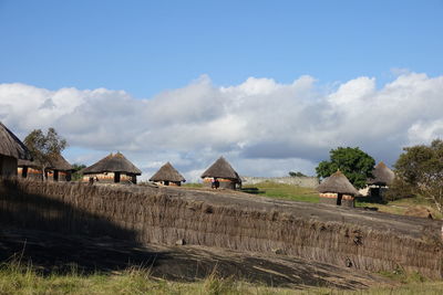 Houses on field against sky