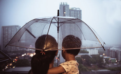 Rear view of man and woman in rain