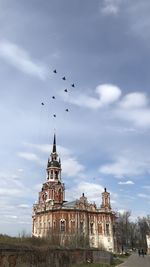 Low angle view of church against sky,  military planes