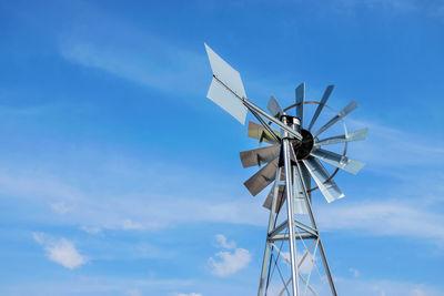 Low angle view of windmill against sky