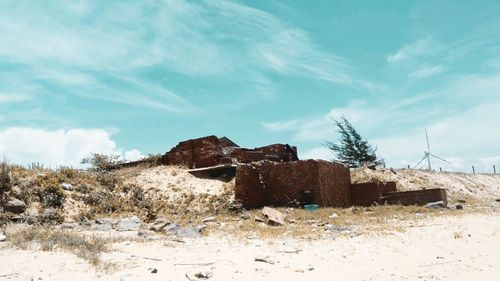 Abandoned built structure in winter against sky