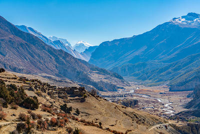 Scenic view of mountains against blue sky