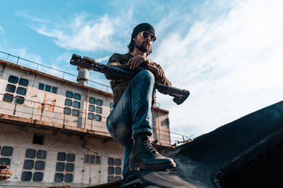 Low angle view of man standing against sky