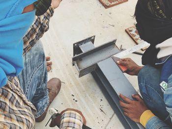 Cropped image of construction workers working at site