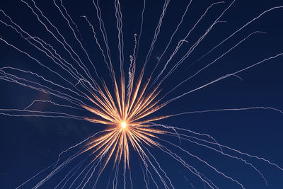 Low angle view of firework display against sky at night