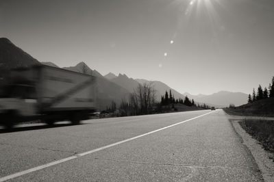 Road by mountain against sky