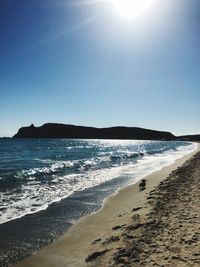 Scenic view of beach against clear sky during sunny day