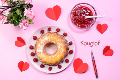 Directly above shot of heart shape on pink cake