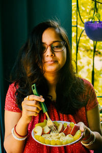 Portrait of young woman eating food. women need quality food for diet.