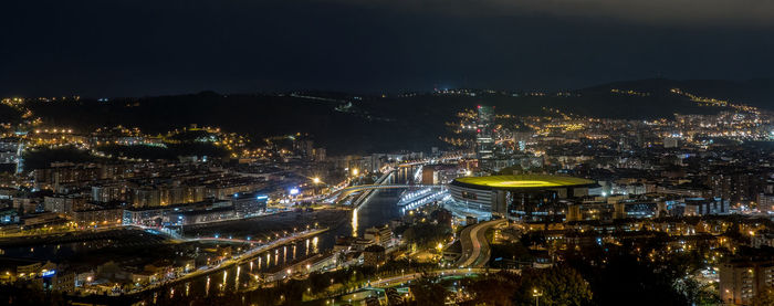 High angle view of illuminated city buildings at night