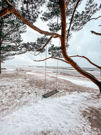 View of swing against sky during winter