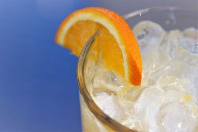 Close-up of ice cubes and lemon slice in drink