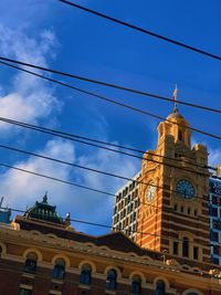 Low angle view of buildings against blue sky