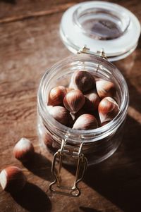 High angle view of hazelnuts in jar on table